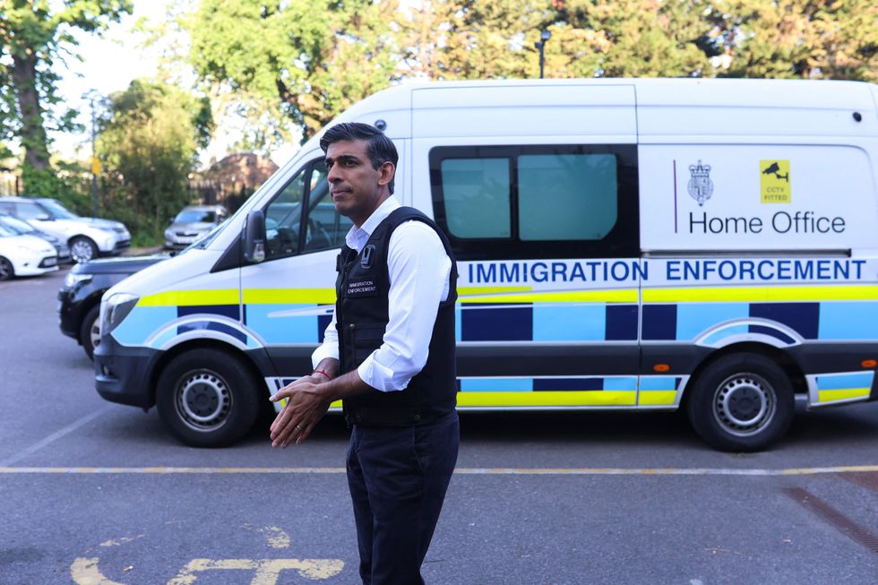Sunak in front of an immigration enforcement van