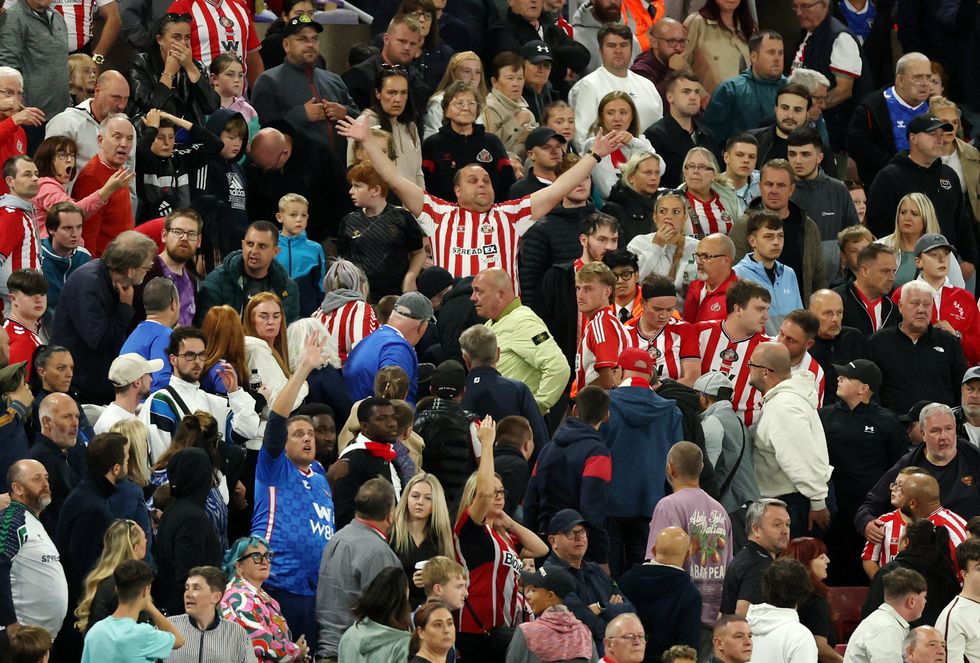Sunderland fans beckon for help after a fan fell ill in the stands