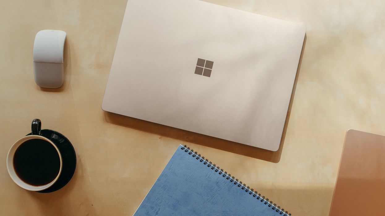 Surface laptop on a table with the Mouse beside it