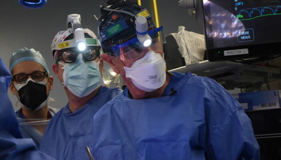 Surgeon Bartley P. Griffith, MD performs a successful transplant of a genetically-modified pig heart on David Bennett