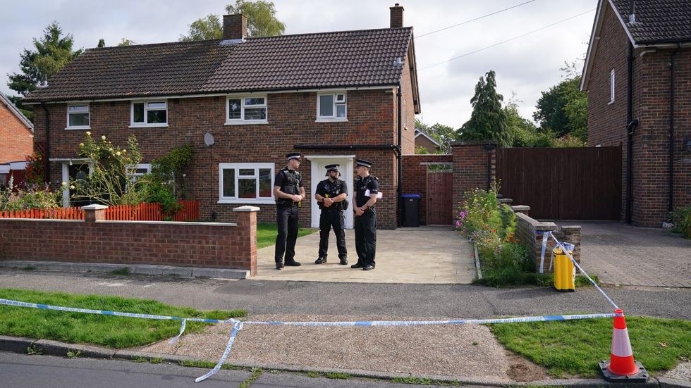 Surrey Police officers outside a property on Hammond Road in Woking