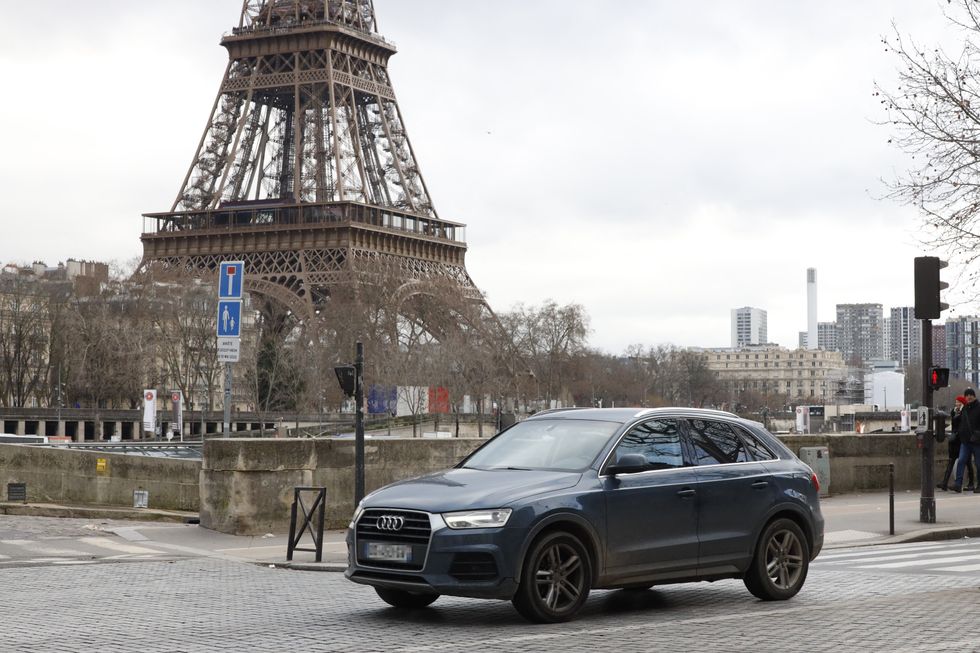 SUV driving outside the Eiffel Tower in Paris