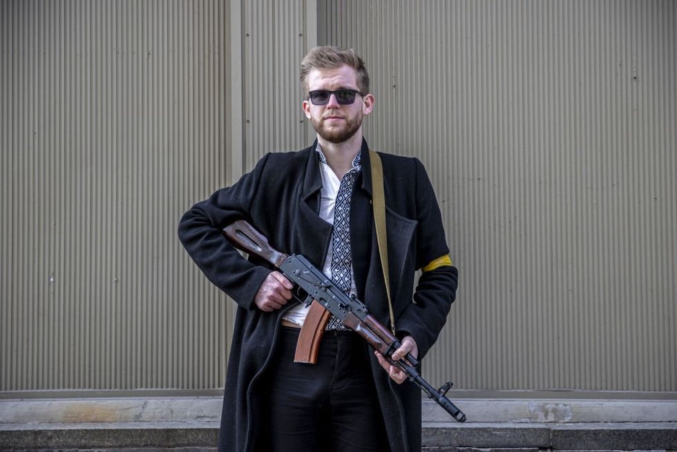 Sviatoslav Yurash is seen at a street with his weapon to defend Kyiv\u200b