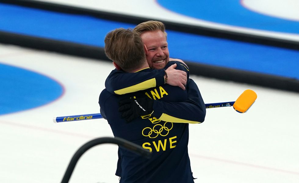Sweden's Niklas Edin and Rasmus Wranaa celebrate victory during the Men's Gold Medal game