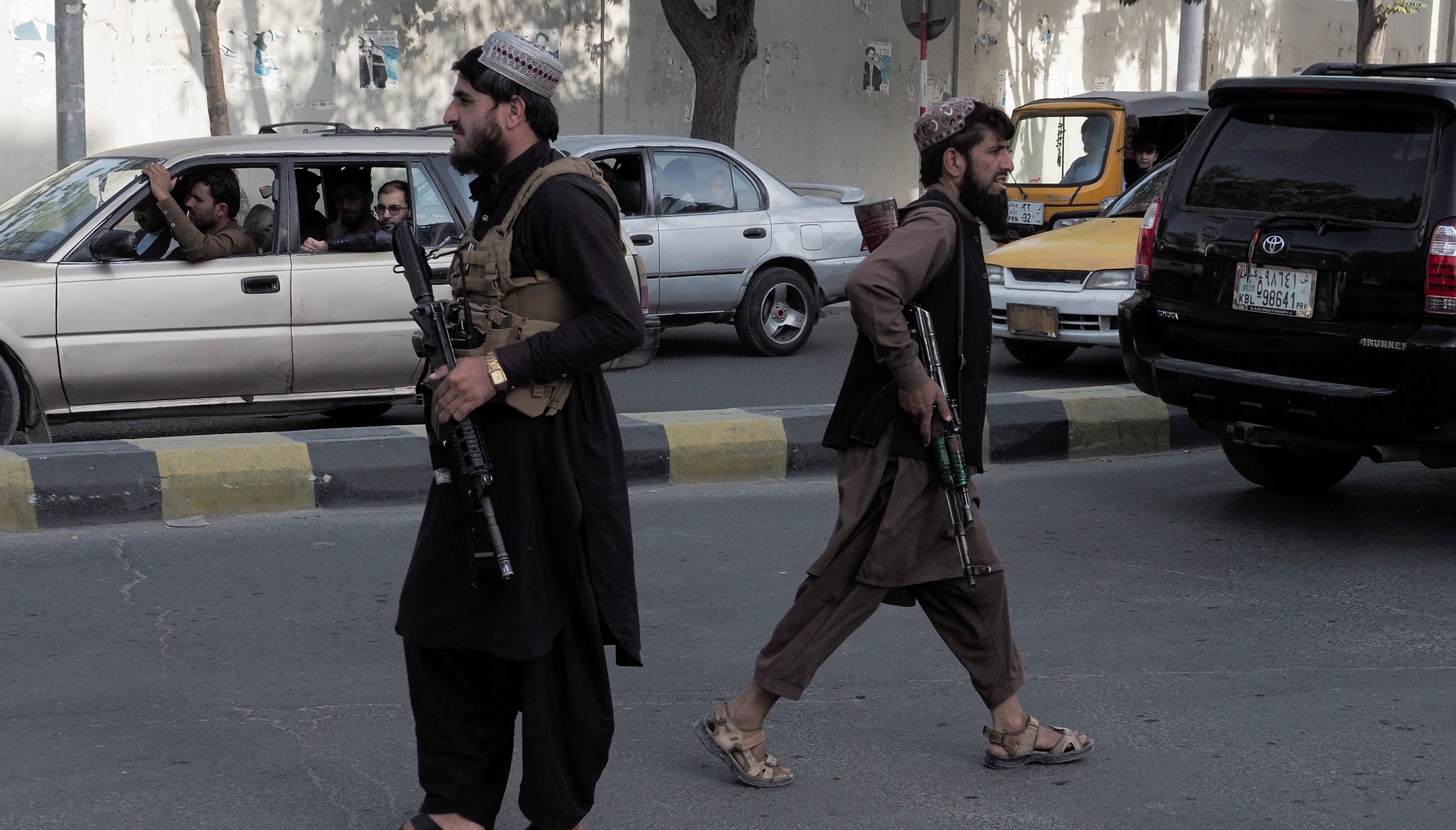 Taliban fighters guard a check-point on a main street in Kabul.