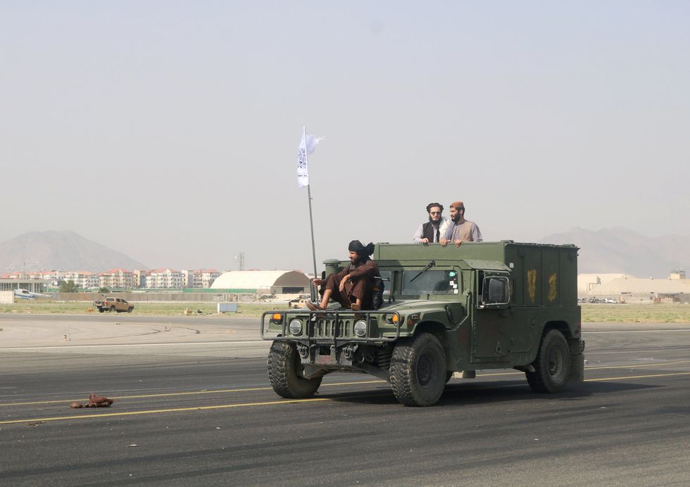 Taliban forces patrol at a runway a day after the U.S. troops withdrawal from Hamid Karzai international airport, Kabul.