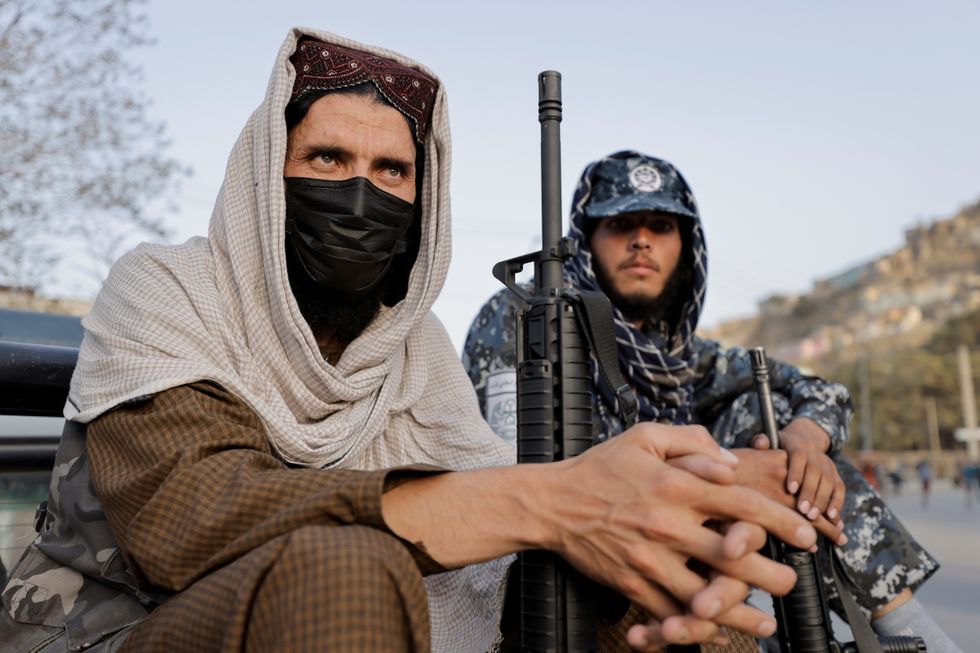 Taliban forces sits at a check point after several civilians were killed in an explosion, in Kabul.