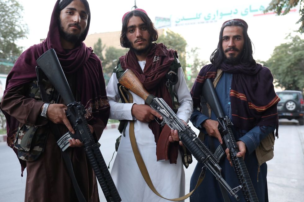 Taliban soldiers pose for a photo in Kabl..