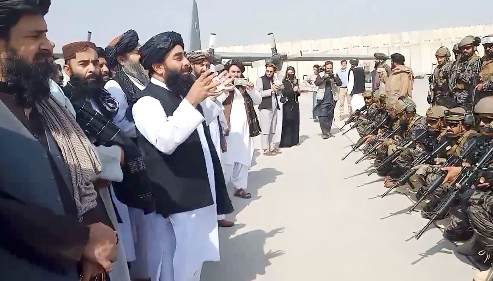 Taliban spokesman Zabihullah Mujahid speaks to Badri 313 military unit at Kabul's airport.