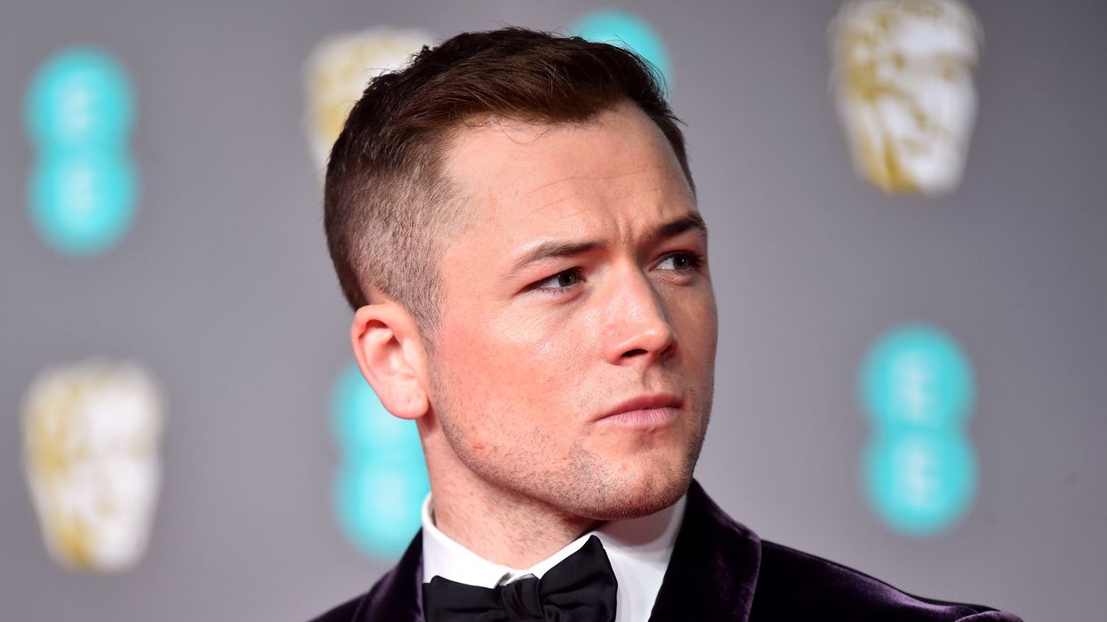 Taron Egerton on the red carpet at a movie premier