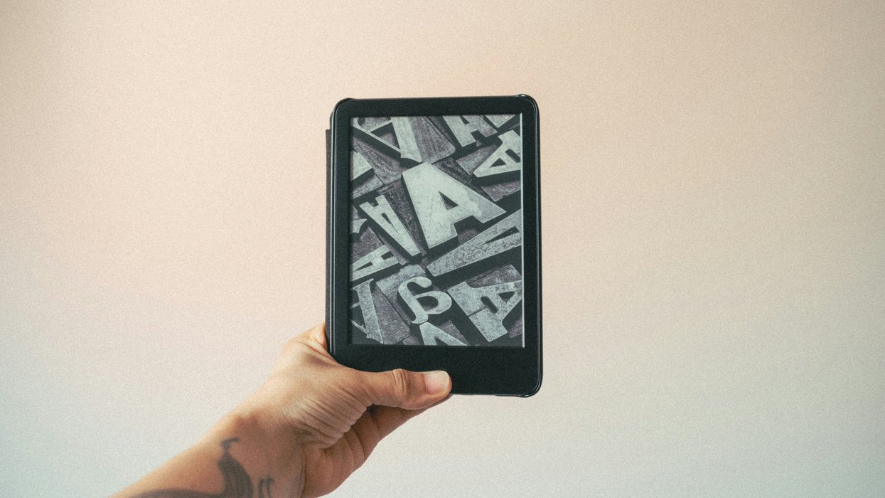 tattoo hand holds a kindle ereader