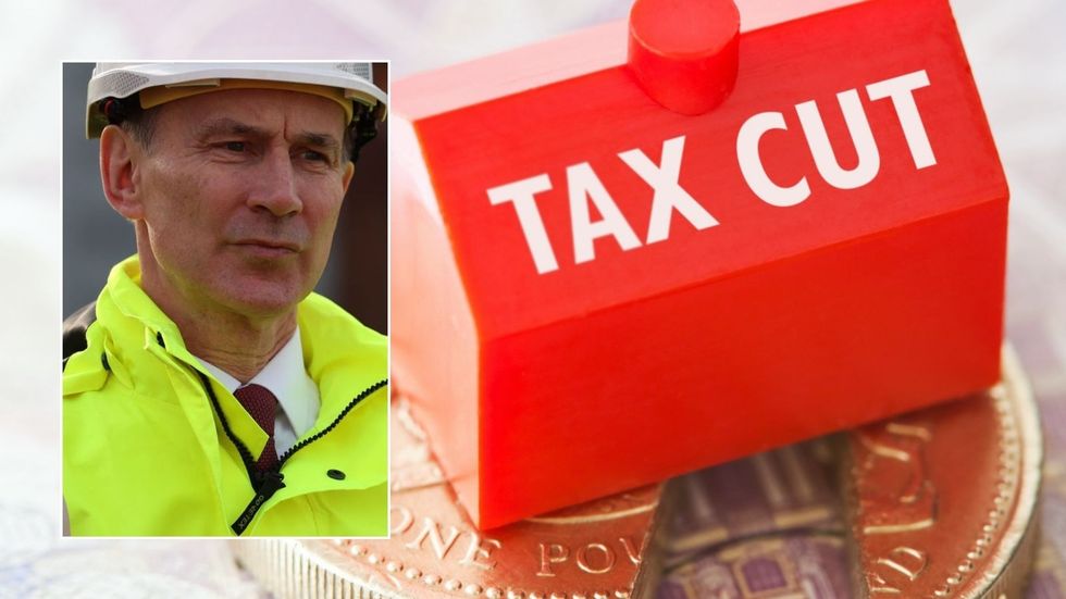 Tax cut sign and Jeremy Hunt at event