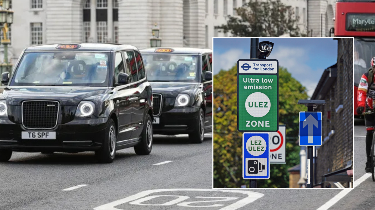 Taxis on the road and a Ulez sign