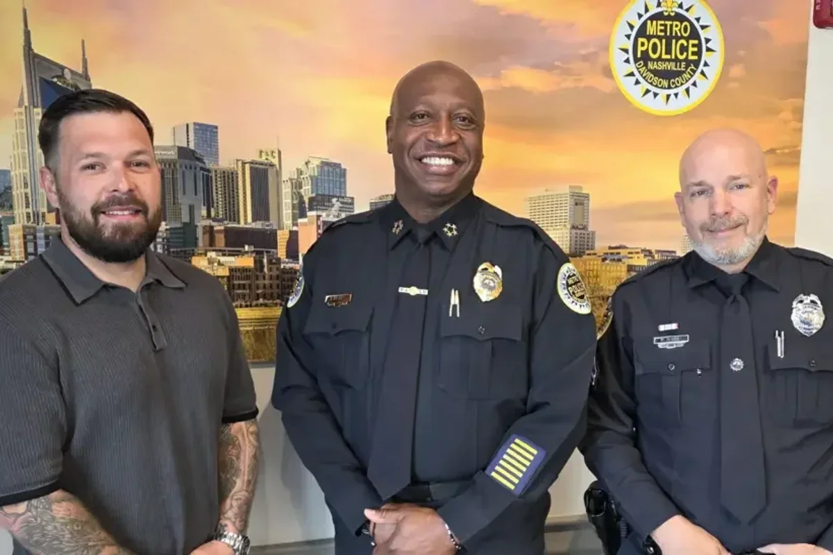 Taylor Johanson (left) with Chief John Drake (centre) and the officer he helped, Peter Kinsey (right), after the incident