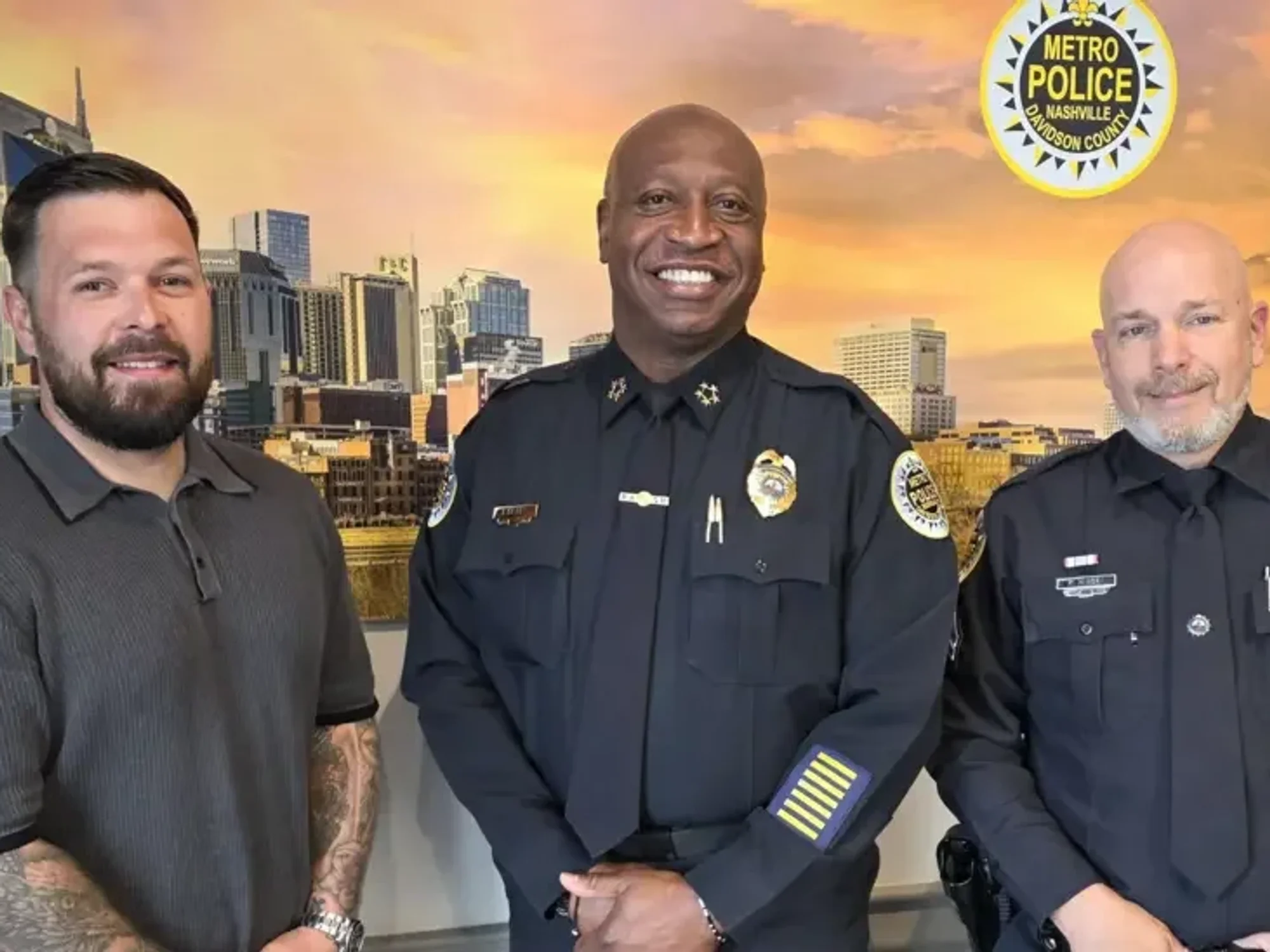 Taylor Johanson (left) with Chief John Drake (centre) and the officer he helped, Peter Kinsey (right), after the incident