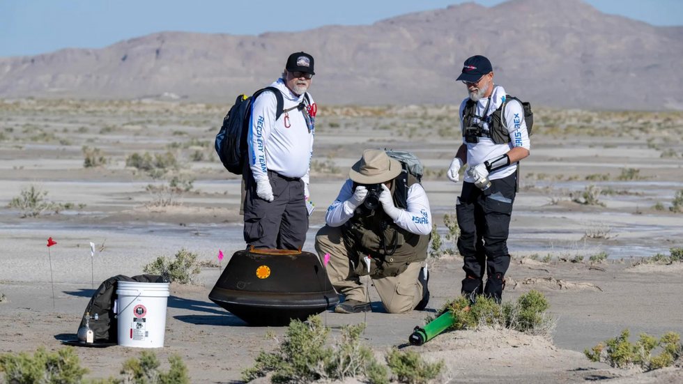 Team with asteroid sample on Earth