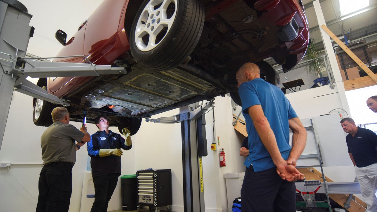 Technicians working on an electric car