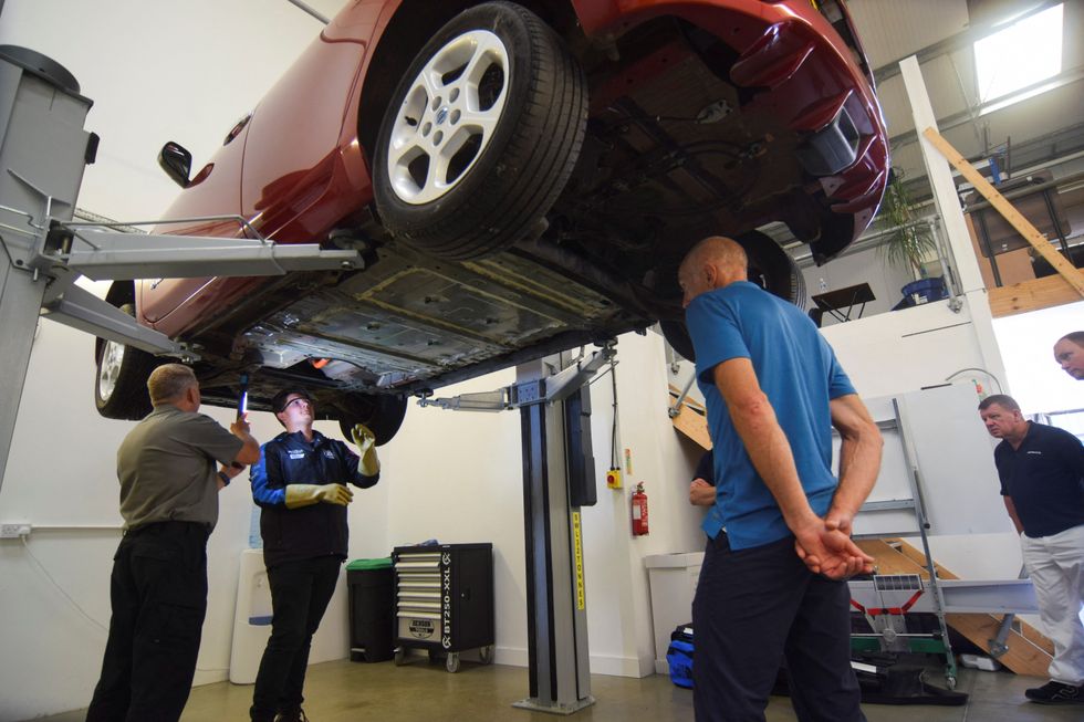 Technicians working on an electric car