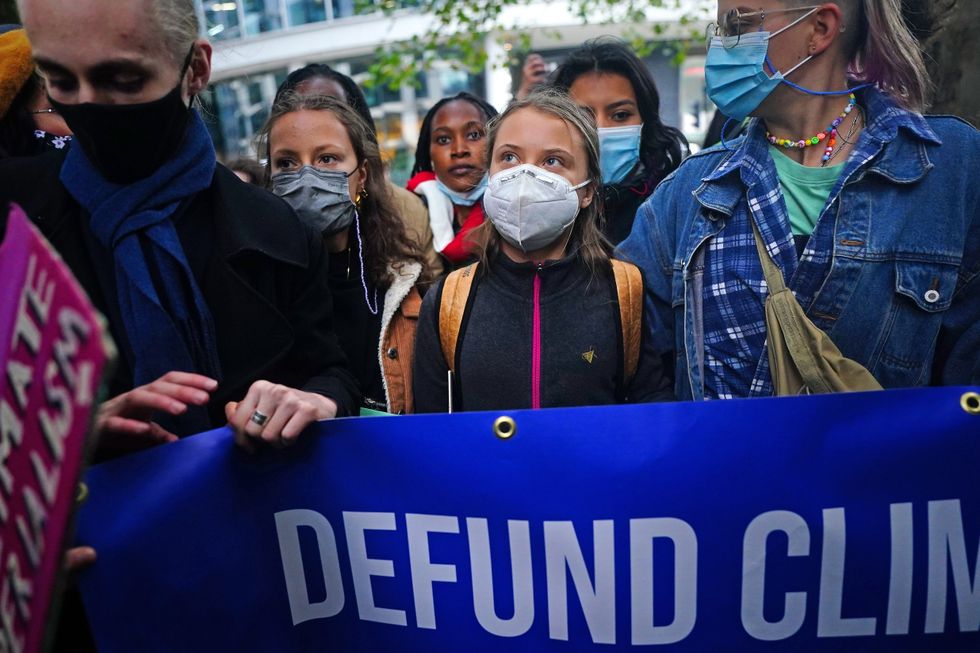 Teenage activist Greta Thunberg (centre) joins activists taking part in the Youth Strike to Defund Climate Chaos protest against the funding of fossil fuels outside Standard Chartered Bank in London.