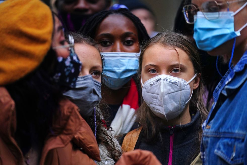 Teenage activist Greta Thunberg (centre right) joins activists taking part in the Youth Strike to Defund Climate Chaos protest against the funding of fossil fuels outside Standard Chartered Bank in London.