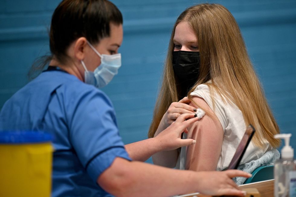 Teenager receives a covid vaccination at the Barrhead Foundry vaccination centre near Glasgow