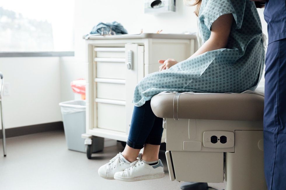 Teenager sits in doctor's office