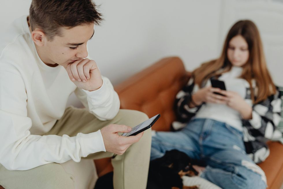 Teenagers scrolling on their mobiles