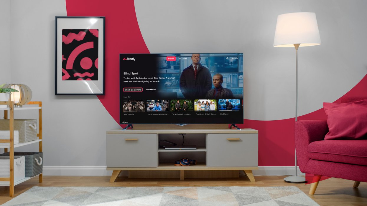 television on a small cabinet with the Wi-Fi symbol on the wall before