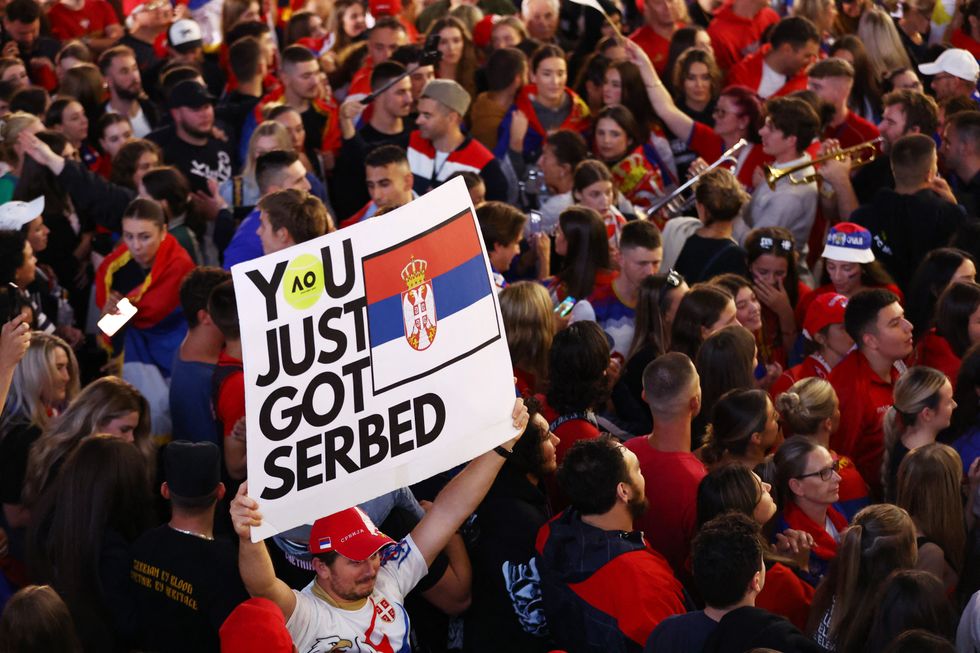 Tennis - Australian Open - Men's Singles Final - Melbourne Park, Melbourne, Australia - January 29, 2023 Fans are pictured with flags and posters as they celebrate Serbia's Novak Djokovic winning his final match against Greece's Stefanos Tsitsipas REUTERS/Carl Recine