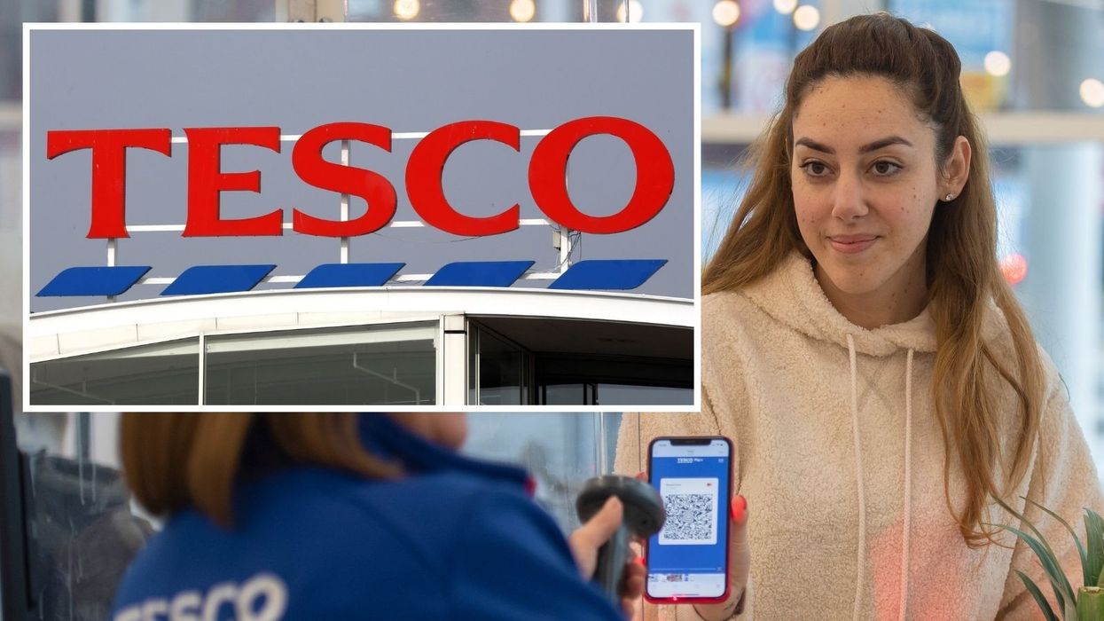 Tesco sign and Tesco Clubcard member showing card on phone