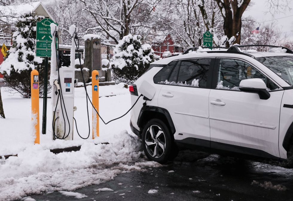 Tesla car charging in the snow