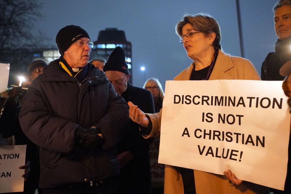 The Archbishop of Canterbury, Justin Welby (left) speaks with Jayne Ozanne (right) and other LGBT+ campaigners and their allies gather outside Lambeth Palace, south London, ahead of a reception for parliamentarians to demand an end to the discrimination against LGBT+ people in the Church of England. Plans to allow the blessing of same-sex civil marriages for the first time were outlined lastweek, but the position on gay marriage will not change and same-sex couples will still be unable to marry at church. Picture date: Monday January 23, 2023.