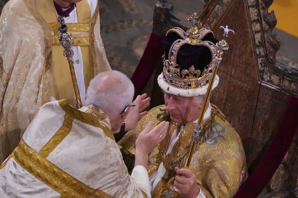 The Archbishop of Canterbury placing the crown on Charles' head