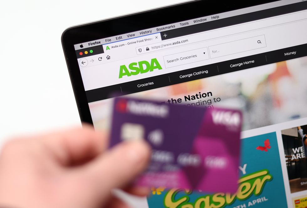 The ASDA website is pictured on a laptop with a bank card