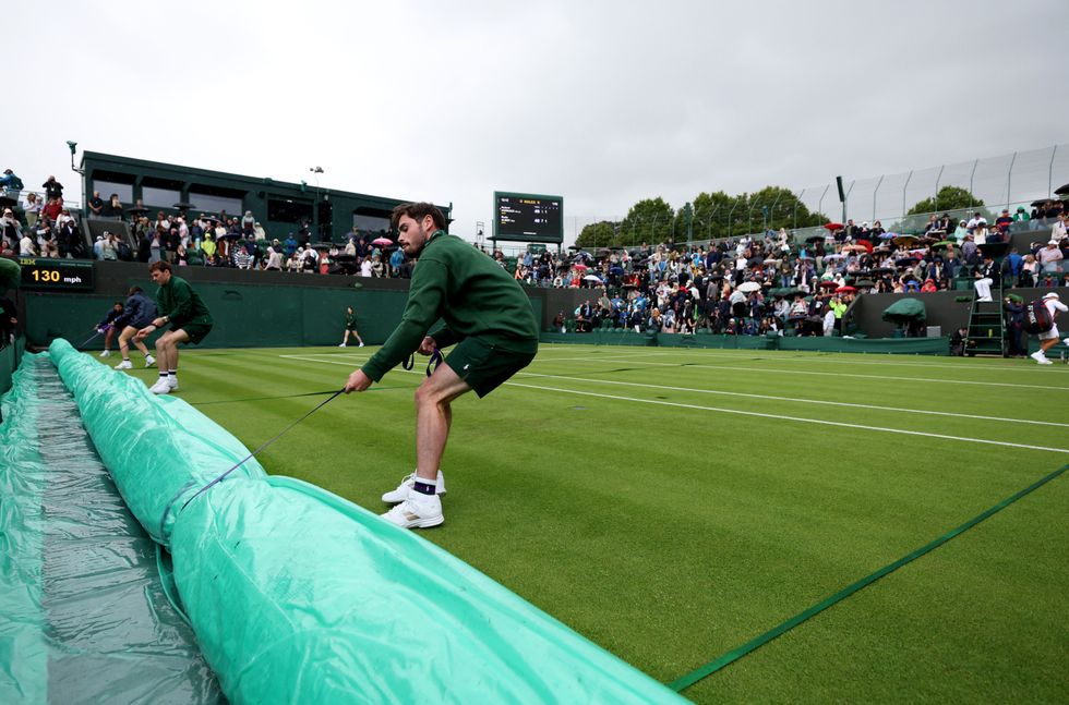 The ball kids are always quick to get the covers on