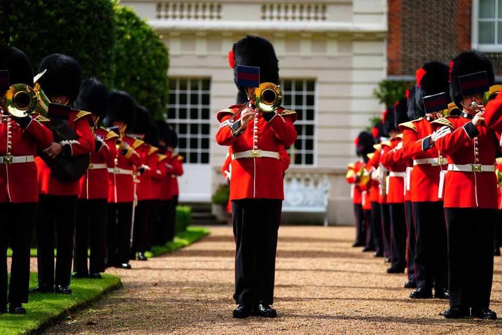 The Band of the Coldstream Guards playing Three Lions and Sweet Caroline in the gardens of Clarence House in London ahead of England's Euro 2020 semi-final game against Denmark on Wednesday. Picture date: Tuesday July 6, 2021.