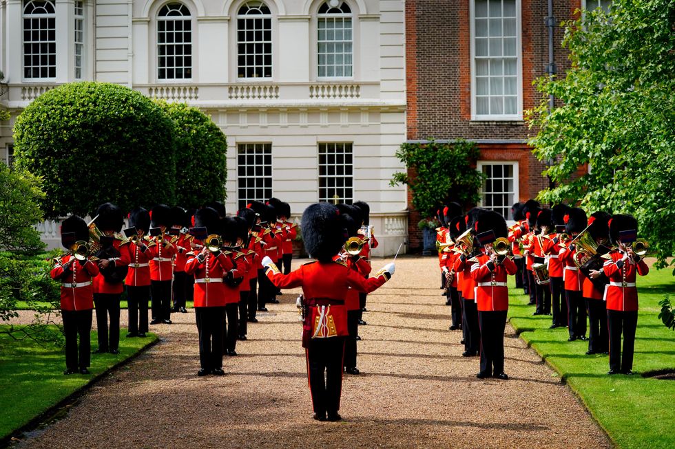 The Band of the Coldstream Guards playing Three Lions and Sweet Caroline in the gardens of Clarence House in London ahead of England's Euro 2020 semi-final game against Denmark on Wednesday. Picture date: Tuesday July 6, 2021.