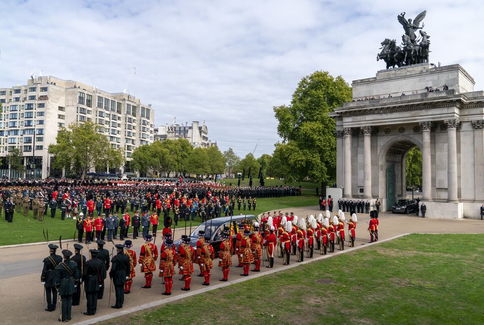 The bearer party place the coffin of Queen Elizabeth II in the state herse for it's journey to Windsor castle following her State Funeral at Westminster Abbey, London.