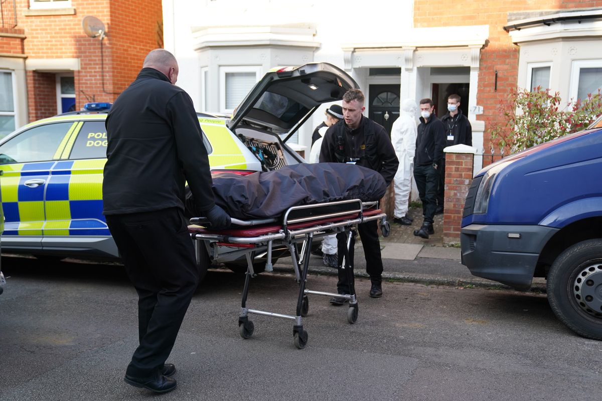 The body is removed from the property in Moore Street, Kingsley, Northampton.
