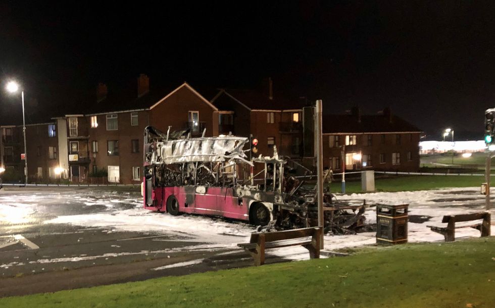 The burnt out double decker bus in Church Road near Rathcoole in Newtownabbey, Co Antrim after it was hijacked and set on fire near a loyalist estate on the outskirts of Belfast. Picture date: Sunday November 7, 2021.