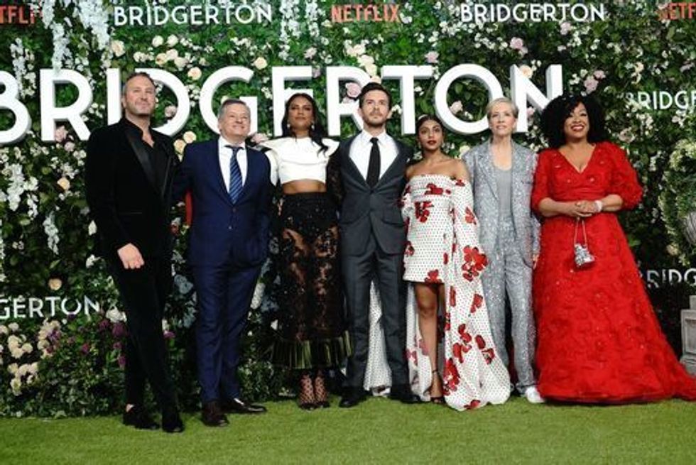 The cast and crew of Bridgerton (left to right) Showrunner Chris Van Dusen, Simone Ashley, Jonathan Bailey, Charithra Chandran, Executive Producer Betsy Beers and Executive Producer and Shonda Rhimes pose for a photo ahead of the world premier of series two of the Netflix period drama Bridgerton, at Tate Modern, London. Picture date: Tuesday March 22, 2022.