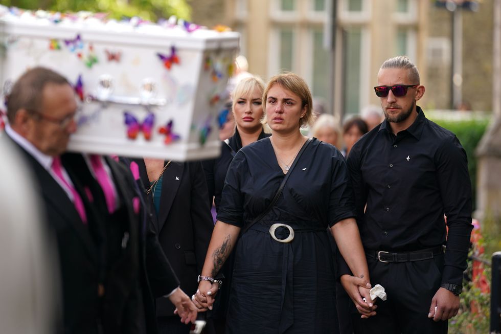 The coffin of nine-year-old stabbing victim Lilia Valutyte being carried into St Botolph's Church in Boston, Lincolnshire followed by her mother Lina Savicke and step-father Aurelijus Savickas.