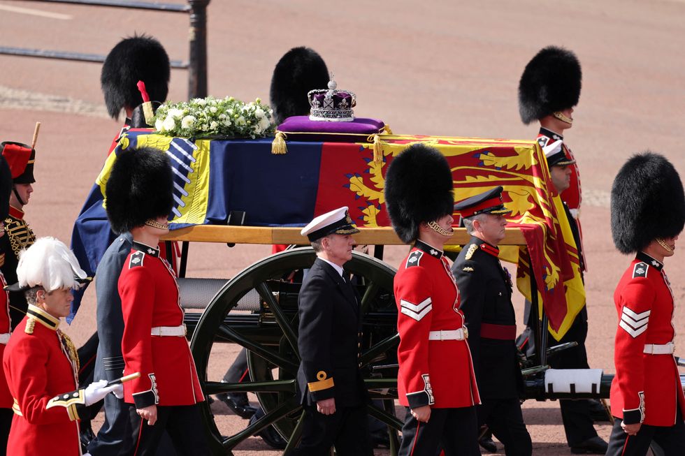 The coffin of Queen Elizabeth II, adorned with a Royal Standard and the Imperial State Crown and pulled by a Gun Carriage of The King's Troop Royal Horse Artillery, is pictured during a procession from Buckingham Palace to the Palace of Westminster, in London on September 14, 2022 Will Haigh/Pool via REUTERS