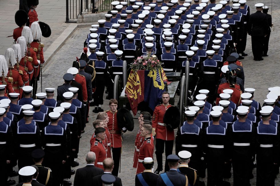 The coffin of Queen Elizabeth II is loaded on to a gun carriage pulled by Royal Navy soldiers to go from Westminster Hall for her funeral service in Westminster Abbey in central London, Monday Sept. 19, 2022. The Queen, who died aged 96 on Sept. 8, will be buried at Windsor alongside her late husband, Prince Philip, who died last year. Nariman El-Mofty/Pool via REUTERS