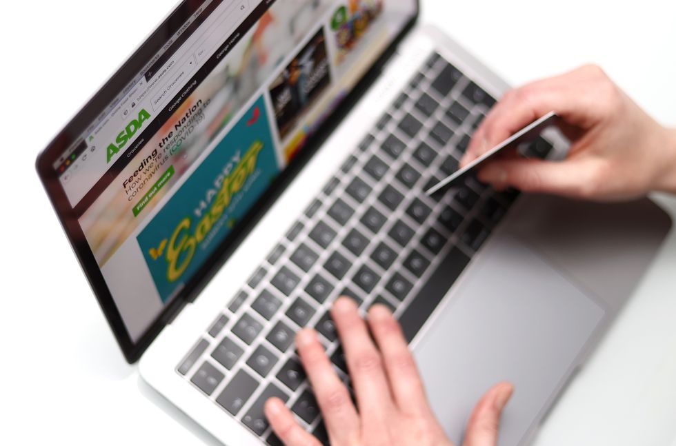 The customer on the ASDA website is pictured holding a bank card