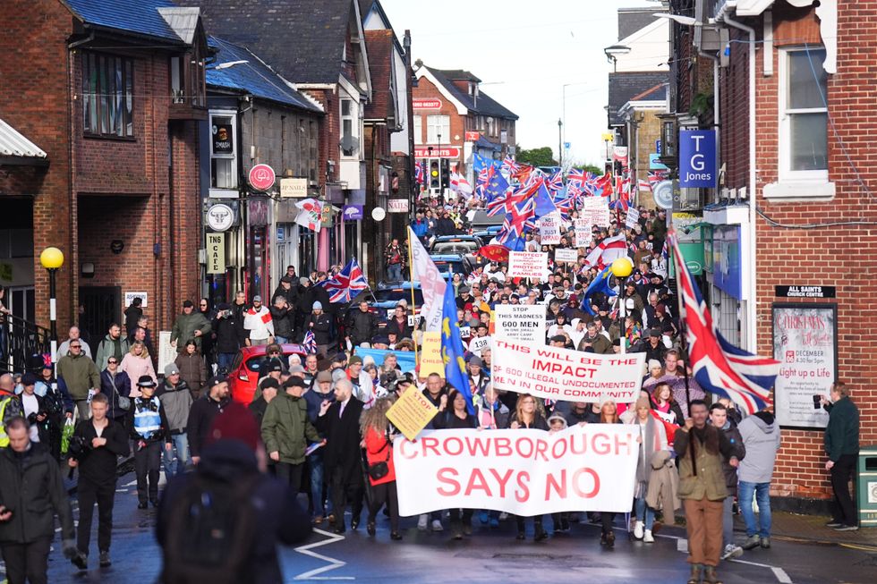 The demonstrators carried English flags and placards through the downpour, maintaining their campaign momentum despite the challenging weather conditions