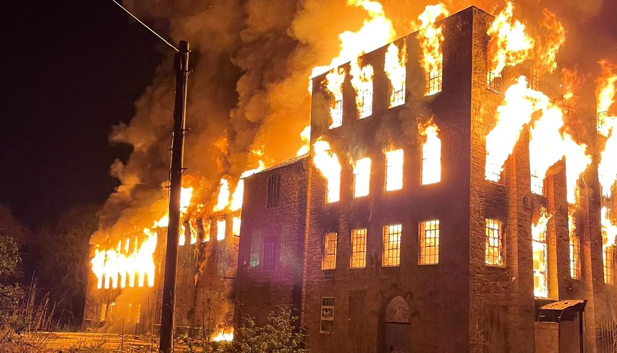The derelict mill engulfed in flames