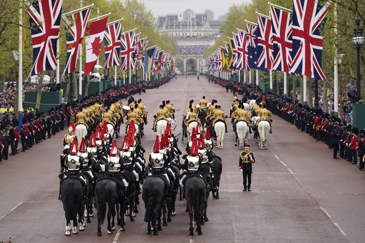 The Diamond Jubilee State Coach is accompanied by the Sovereign's Escort of the Household Cavalry as it arrives at Buckingham Palace ahead of the coronation ceremony of King Charles III and Queen Camilla in central London