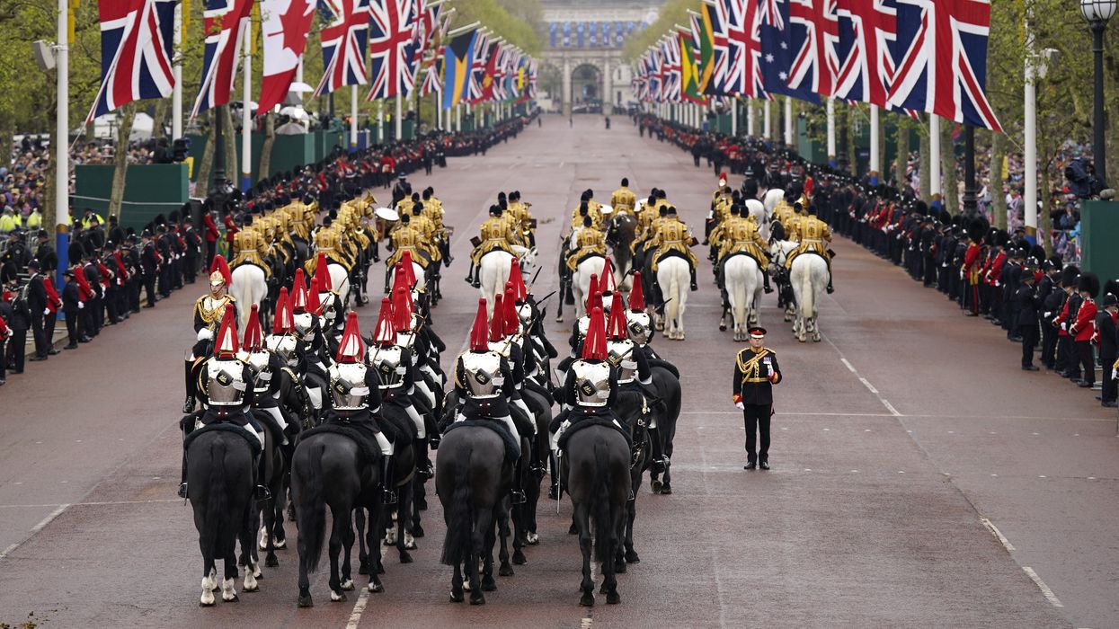 The Diamond Jubilee State Coach is accompanied by the Sovereign's Escort of the Household Cavalry as it arrives at Buckingham Palace ahead of the coronation ceremony of King Charles III and Queen Camilla in central London