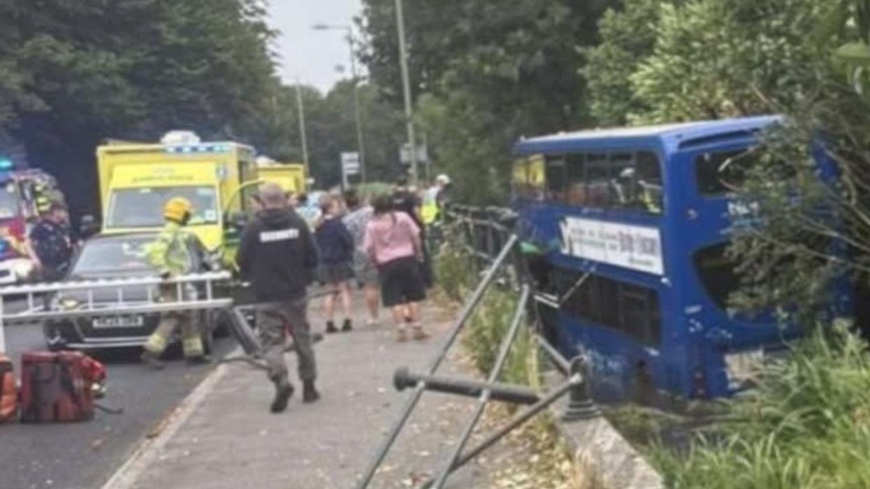 Three seriously injured after double-decker bus carrying schoolchildren crashes off road and into river